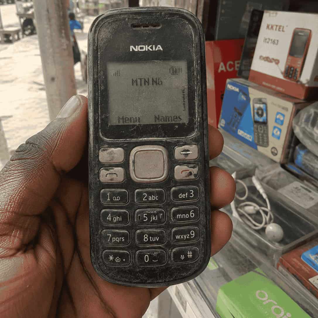 A worn Nokia-style feature phone on MTN Nigeria, the hardware Ticket IT USSD was built for